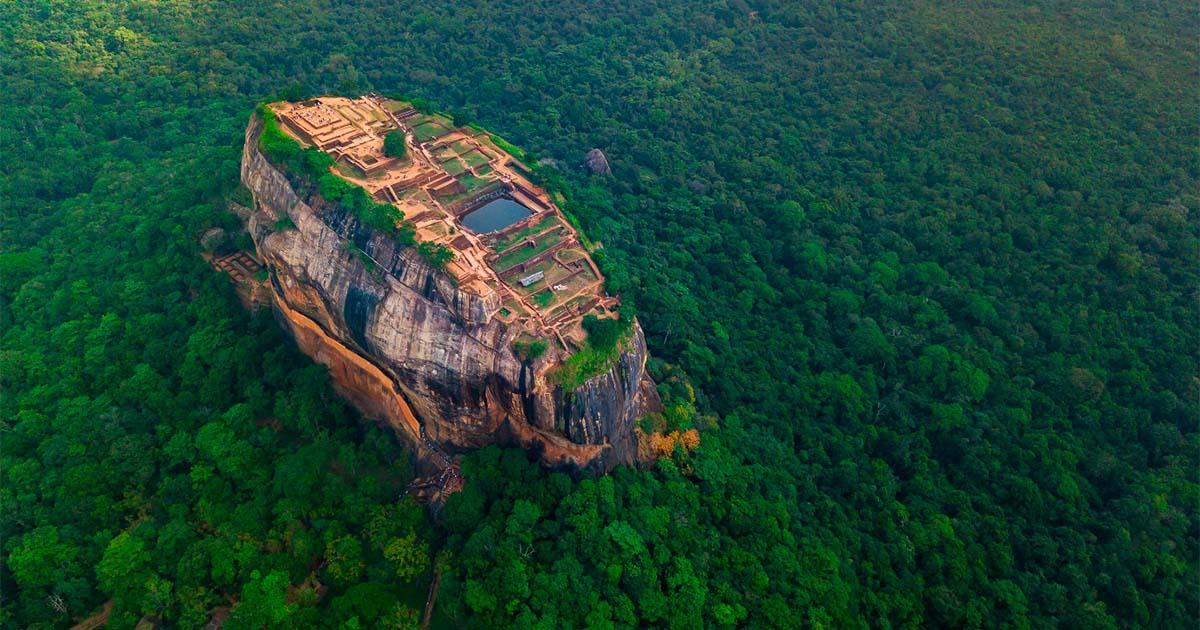 Sigiriya Rock rising above the green forest canopy